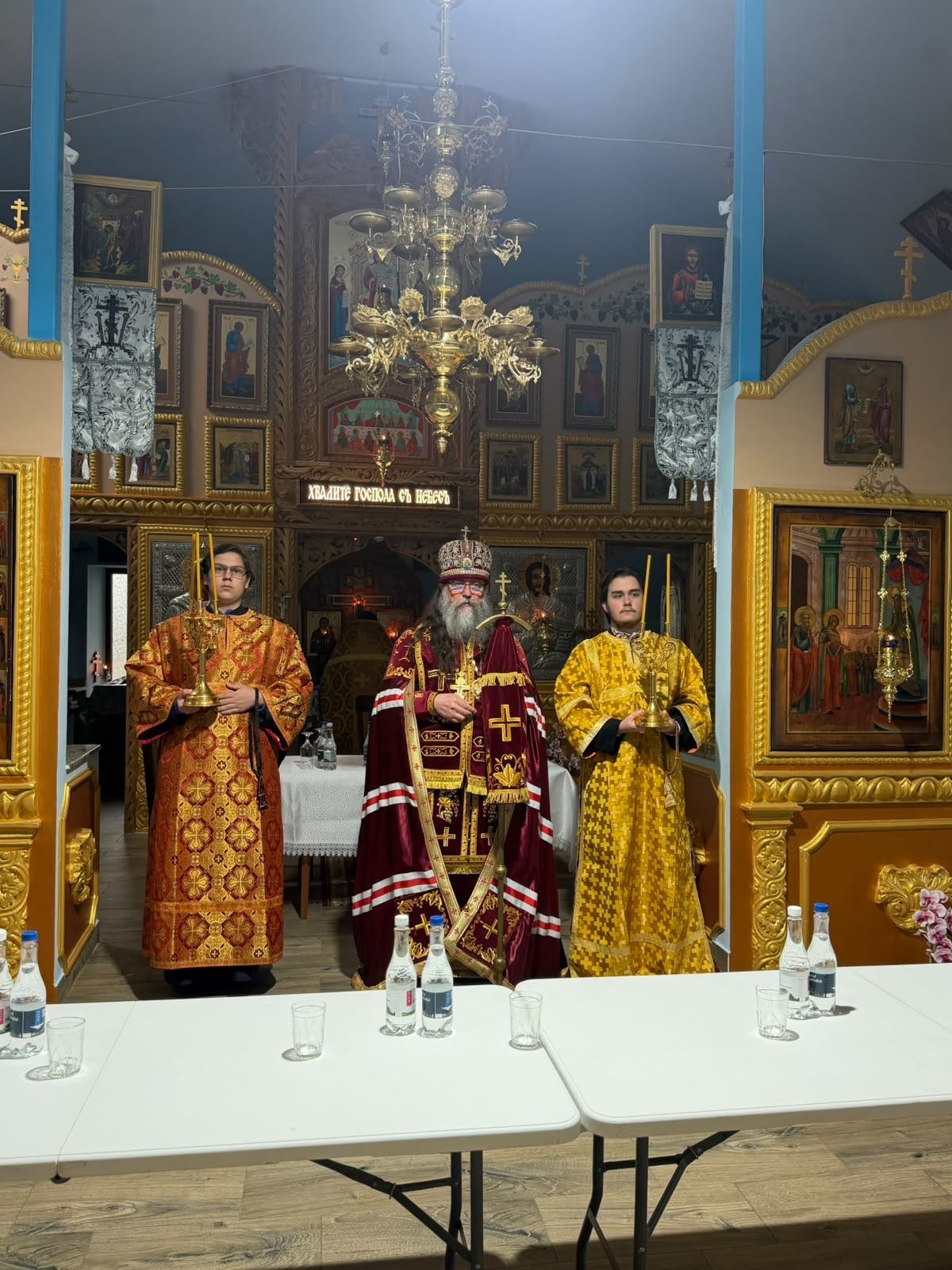 Metropolitan Leontie in hierarchal vestments between two subdeacons holding candlesticks