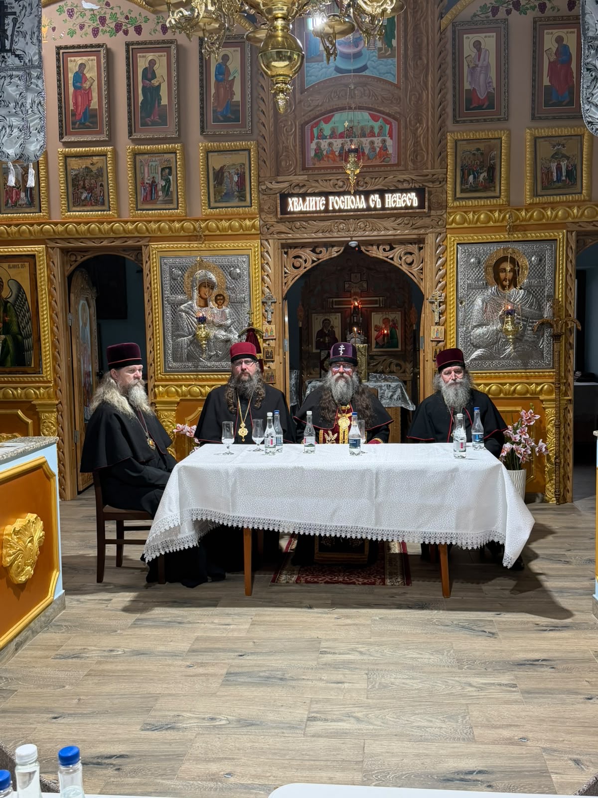 The hierarchs at the table of the Episcopal Spiritual Council before the iconostasis